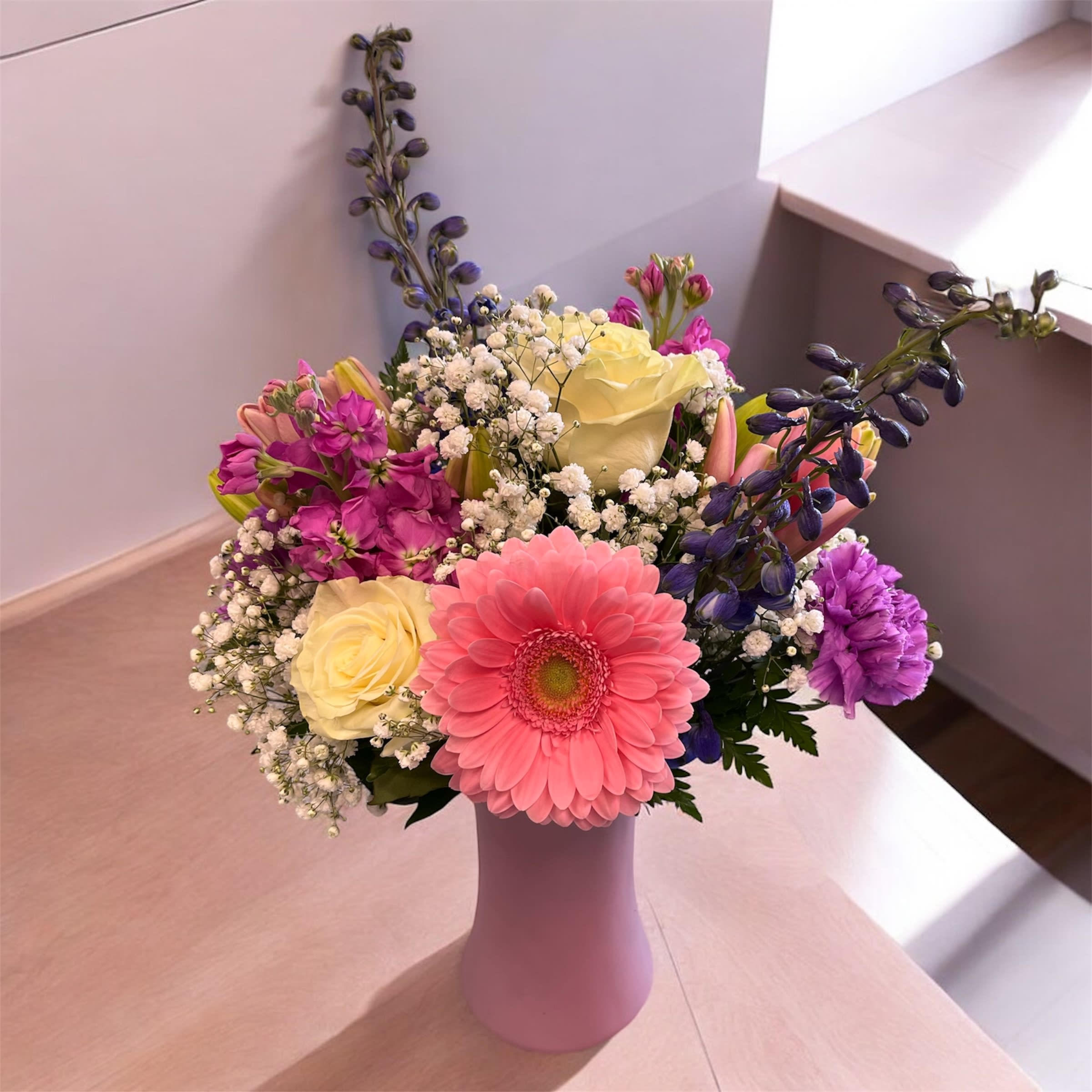 Madly In Love Arrangement - &quot;Madly In Love&quot; is a serene floral arrangement designed to evoke warmth, peace, and emotional connection. Featuring soft blooms, it combines gentle hues of pink, white, and greens to create a soothing, affectionate atmosphere. This arrangement, with its delicate blend of flowers, symbolizes care, compassion, and the gentle embrace of love, offering a sense of comfort and tranquility to those who receive it. Perfect for simply expressing heartfelt emotions.