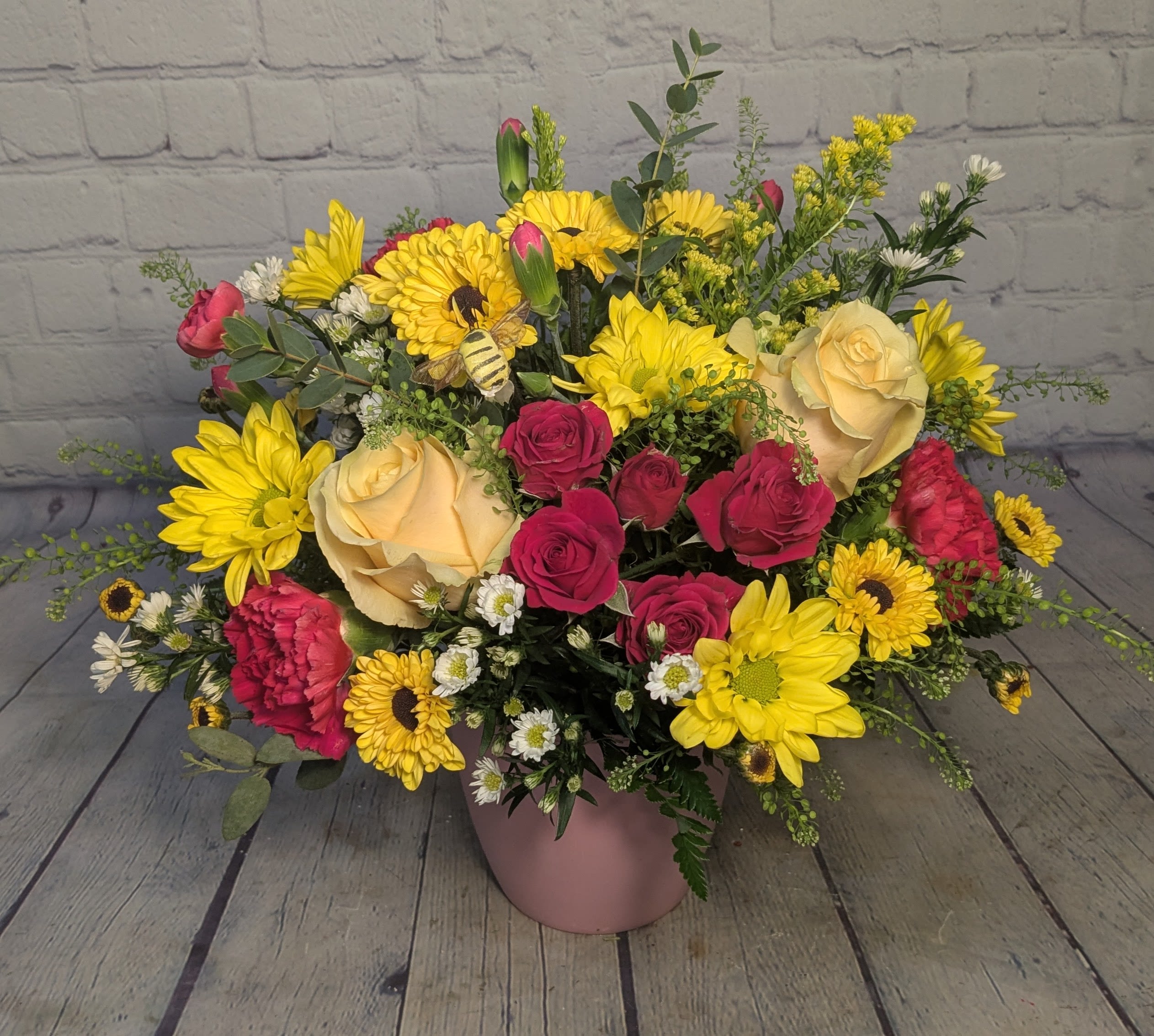 Bee Mine - A bright and colorful mix of hot pink &amp; yellow. This bouquet features roses, spray roses, daisies, fresh persian cress, hot pink carnations, and an adorable bee pick. 