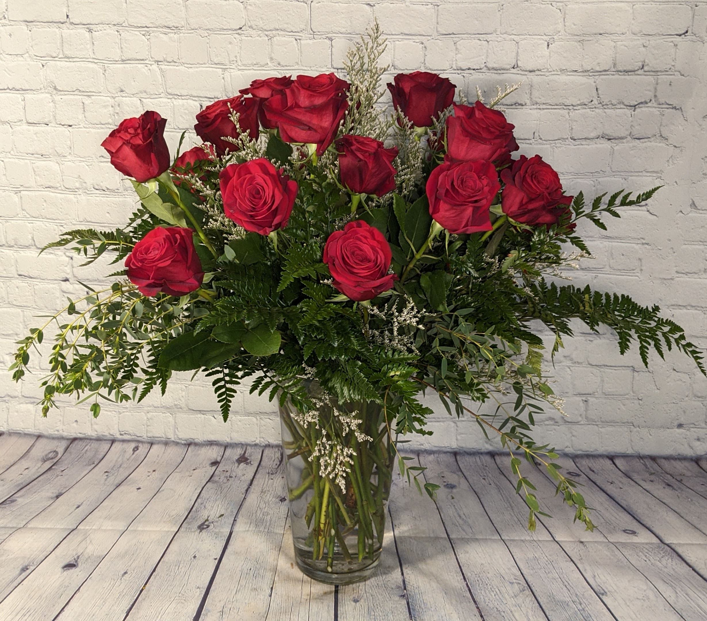 Two Dozen Long Stemmed Roses Two Dozen Long Stemmed Roses - Twenty-four beautiful red roses are hand arranged amongst a variety of lush greenery to create a bouquet that is sure to impress.