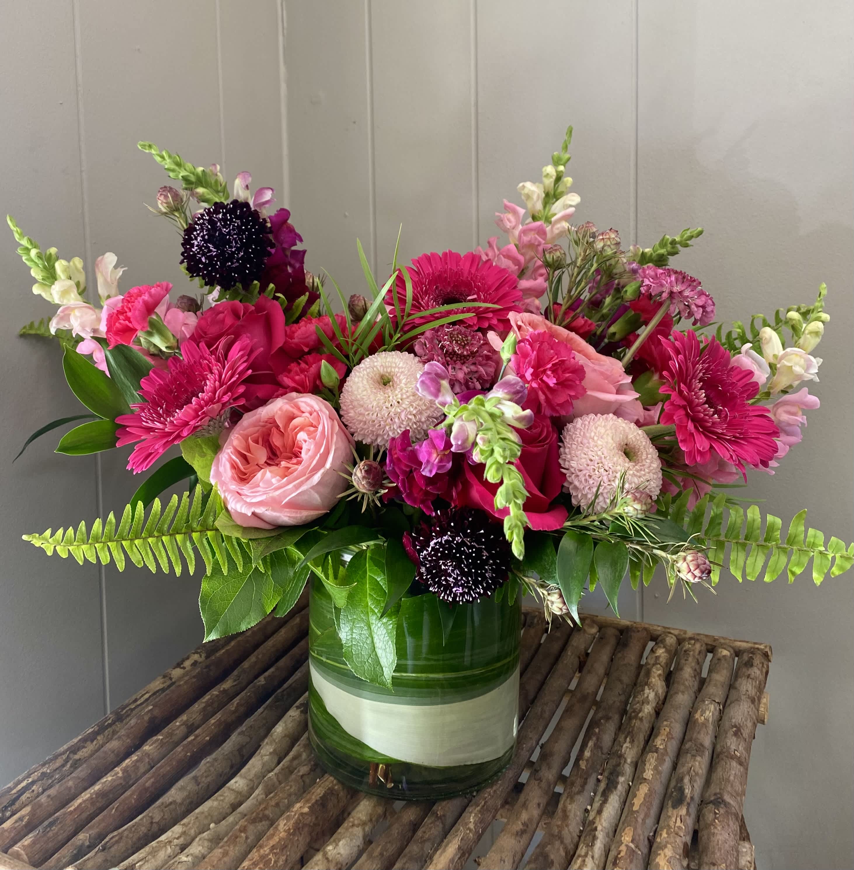 Berry Berry - Bursting with hot pink flavor, this arrangement is sure to make you feel like summer. Including roses, gerbera daisies, mums, carnations, snapdragons, and more.
