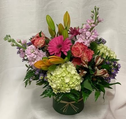 Delighted in Delray  - The Delighted in Delray floral arrangement is a burst of vibrant color, featuring a captivating combination of lilies, stock, hydrangea, spray roses, and gerberas. Set in a stunning glass vase adorned with shades of pink, green, and orange, this arrangement is a true feast for the eyes.  