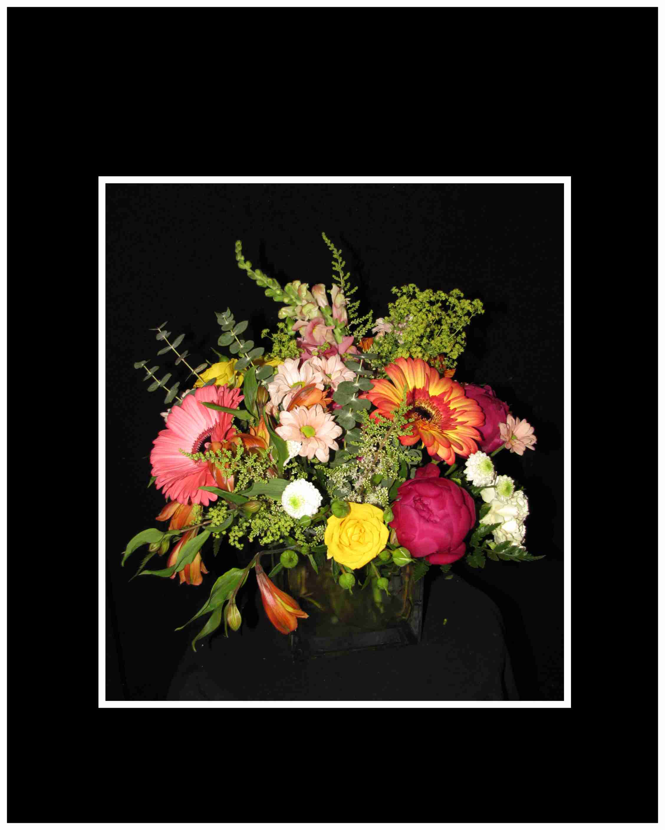 Sunny Days Bouquet Sunny Days Bouquet - This bouquet is done in a clear glass vase with gerbera daisies, peonies, spray roses, mums, snap dragons, eucalyptus, an overflowing arrangement full of Sunshine. Approximately 15"H x 15"W.