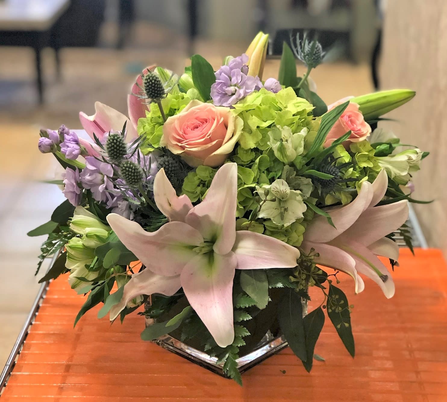 Jewels - Delight in the modern and captivating beauty of our Green Hydrangea, Lavender Stock, and Pink Rose Arrangement. Skillfully crafted by our talented artisans, this stunning floral creation is a feast for the eyes.  