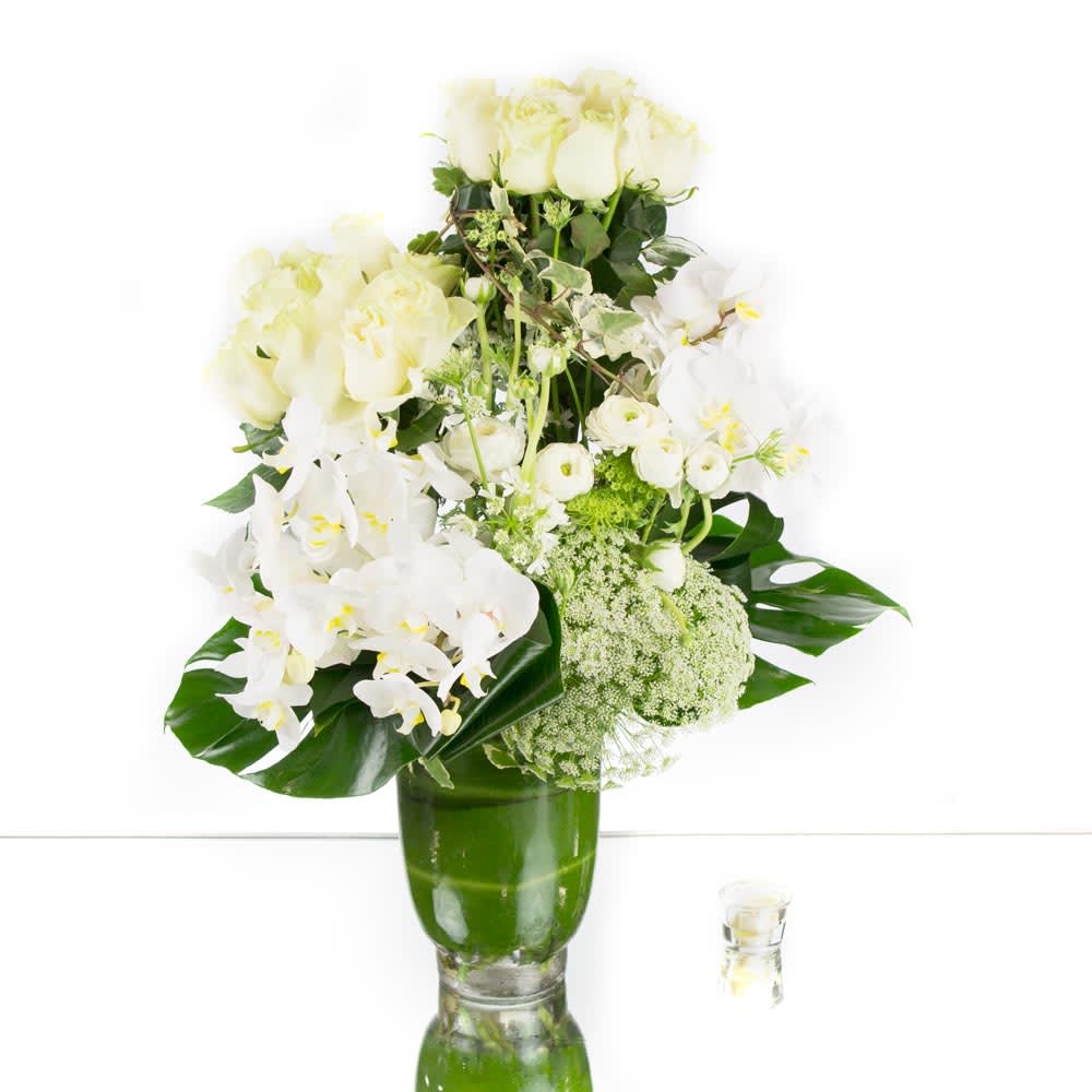 Treasure in white  - Experience the minimalist elegance of our all-white flower arrangement, crafted with care and artistry. This stunning ensemble features a collection of snow-white roses, elegant orchids, delicate ranunculus, and other white blossoms that perfectly complement one another. Each flower is hand-selected for its beauty and the way it harmonizes with the other elements in the arrangement.  