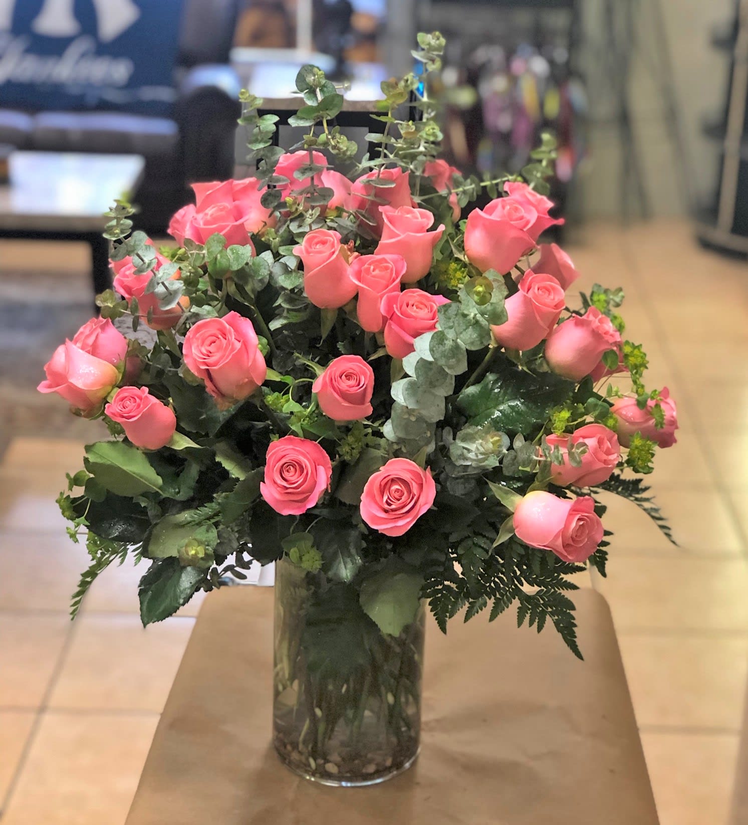 Three Dozen Pink Roses - Embrace the beauty of grace and femininity with our exquisite arrangement of 36 pink long stem roses, artfully displayed in a stunning glass vase. These delicate roses, in various shades of pink, symbolize admiration, appreciation, and gentleness.  
