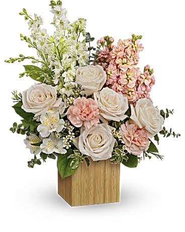 You're Adored Bouquet You're Adored Bouquet - Celebrate your adoration with this artistic bouquet of creamy blooms and lush greens in a stylish, eco-friendly bamboo cube! Crème roses, white larkspur, peach stock, white alstroemeria and white waxflower are arranged with variegated pittosporum, lemon leaf and spiral eucalyptus. Delivered in Teleflora's Small Bamboo Cube.