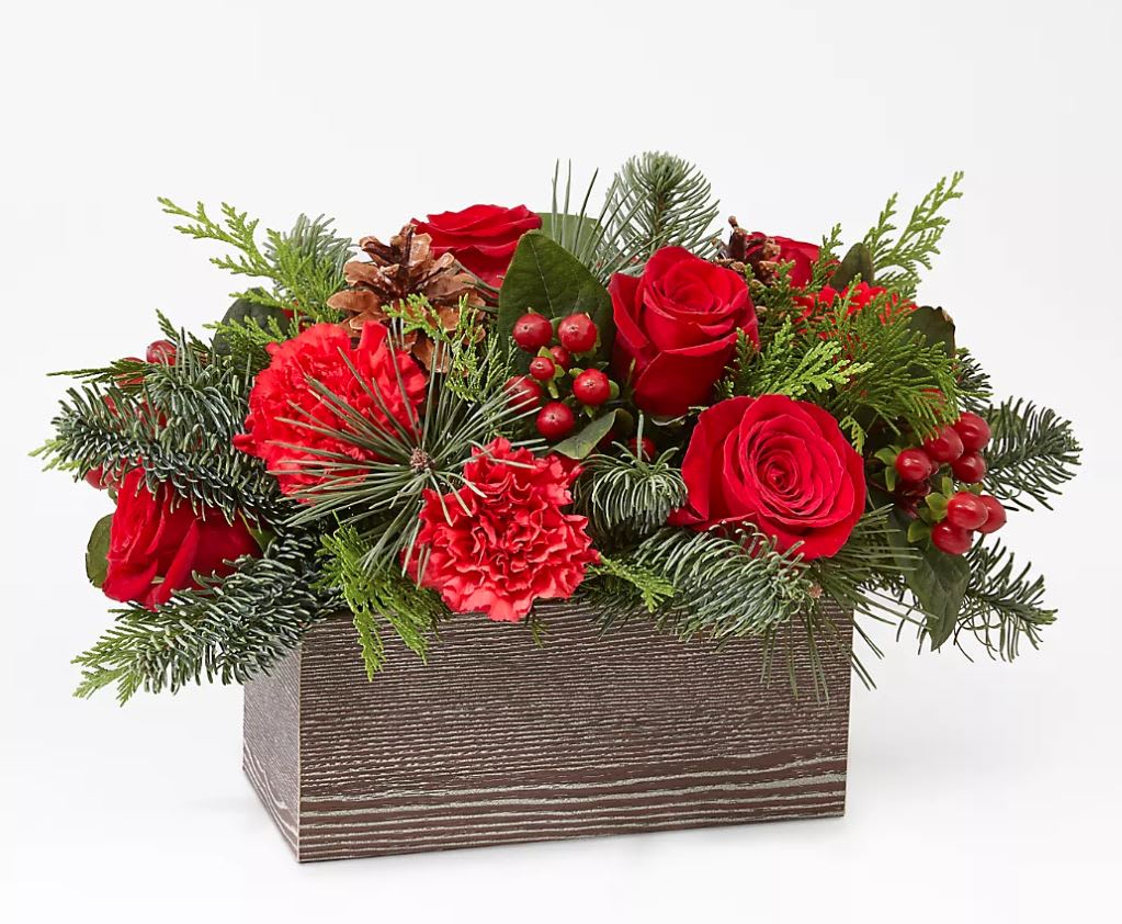 Christmas Cabin Bouquet - Inspired by the rustic charm that comes with the holiday season, elevate your décor with an array of fresh red blooms and greenery.