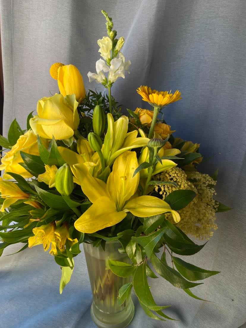  Here Comes The Sunshine - Yellow  fresh cut field flowers. Alstro. and seasonal yellow fillers  in a clear vase.