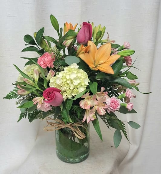 Life is Good BB Life is Good BB - Product Information Introducing "Life is Good," a delightful flower arrangement that combines vibrant shades of orange and pink to create a harmonious and stunning display. This arrangement features a captivating blend of orange lilies, pink roses, mini pink spray roses, pink alstroemeria, mini green hydrangea, lush greenery, and filler flowers, all artistically arranged in a traditional style vase. Substitution Policy In some instances, our photo may represent an overall theme or look and include a one-of-a-kind vase which cannot be exactly replicated. Although the actual bouquet may not precisely match the photo, its temperament will. Occasionally, substitutions of flowers and/or containers happen due to weather, seasonality and market conditions which may affect availability. If this is the case with the gift you’ve selected, we will ensure that the style, theme and color scheme of your arrangement is preserved and will only substitute items of equal value or higher value. If any design elements are of major importance to your order, please include them in the florist instructions at checkout or contact us to ensure availability.