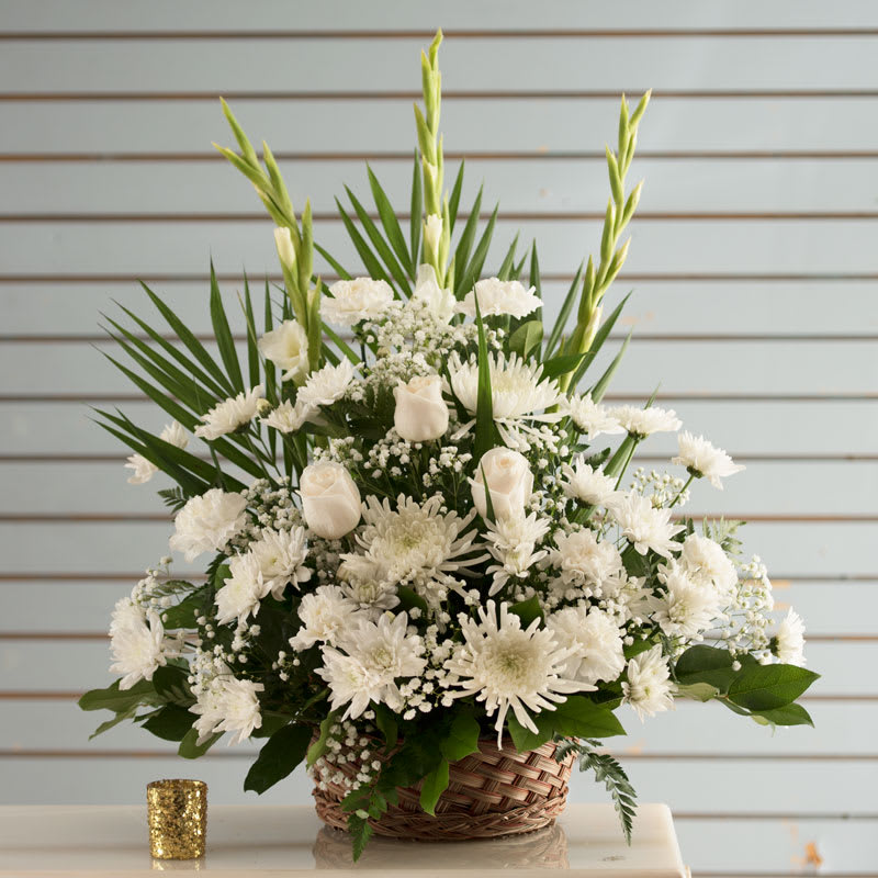 Sympathy Basket Sympathy Basket - All white sympathy arrangement in a basket includes, Asiatic Lilies white roses, carnations, mums and mixed greenery.