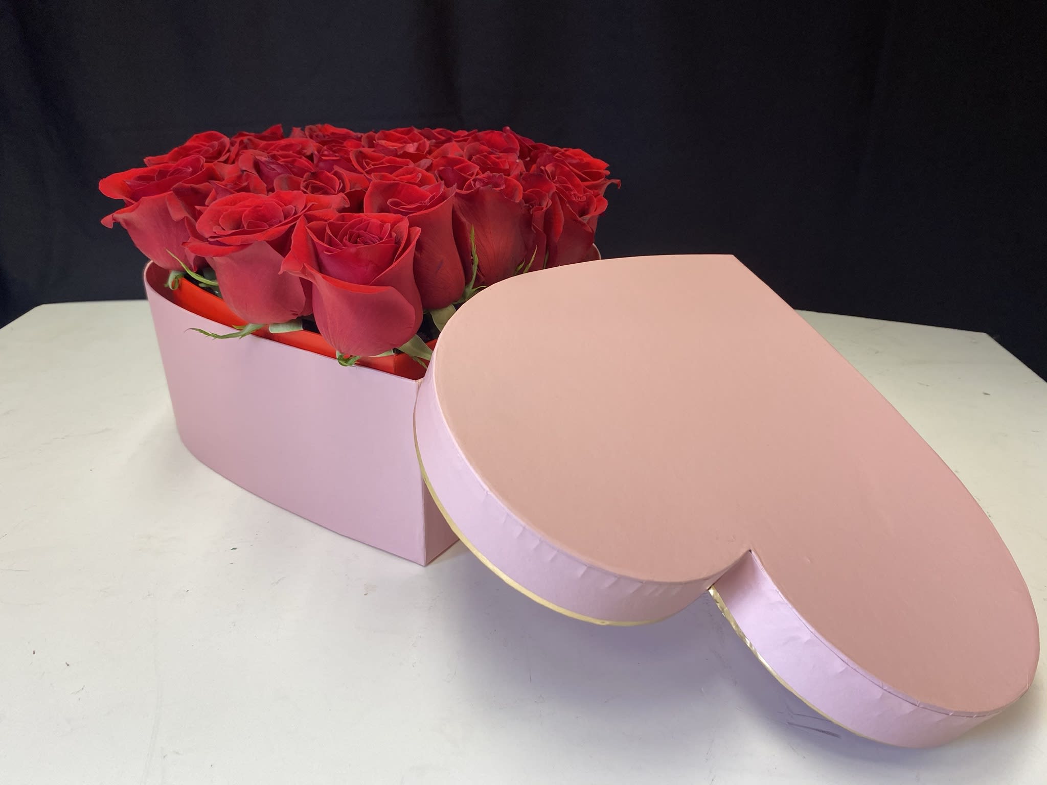 Roses in a heart box - Freshly picked red roses arranged in a heart shape box.