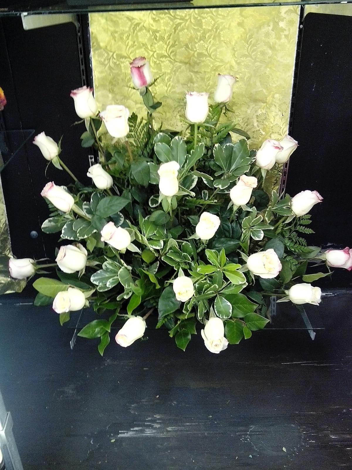Roses in White - This beautiful large arrangement comes with twenty four large stem white roses mixed with eucalyptus and greenery.   