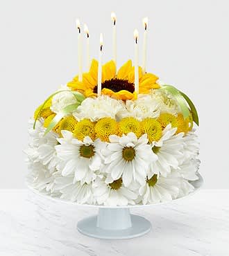 Yellow floral cake Yellow floral cake - a beautiful display of fresh florals expertly designed to look like a cake. Looks good enough to eat!
