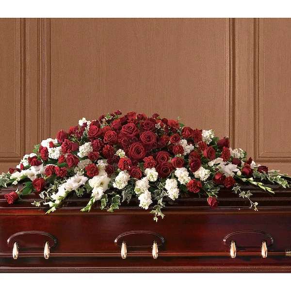 T226-3A Garden of Grandeur Casket Spray - A traditional tribute that communicates deep love and eternal commitment. This dramatic red and white casket spray is ideal for a full couch or closed casket, mixing dozens of deep red roses with the pure white beauty of gladioli and stock. Red roses, spray roses and carnations along with graceful white gladioli and stock are arranged beautifully with ivy and salal.