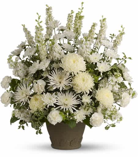Pure and True Arrangement - This magnificent bouquet of classic white flowers arranged in a graceful Grecian Garden urn is a pure and true expression of sympathy and love remembered. Approximately 25 inches wide and 27 inches tall.