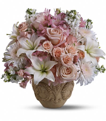 Garden of Memories Arrangement - A garden of heavenly blooms offers an elegant and timeless tribute, beautifully honoring the spirit of the departed. Hand-delivered in the stylish Garlands of Grace urn, these light pink hydrangea and roses are paired together with white lilies and stock. Approximately 19 inches wide and 18 inches tall.