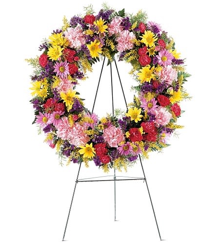 Eternity Wreath Standing Spray Eternity Wreath Standing Spray - Filled to the brim with bright colorful flowers, this standing spray is sure to display your eternal affection for your deceased loved one. A mixture of yellow and purple daisy chrysanthemums, red and pink carnations are brightly displayed on a classic standing easel.