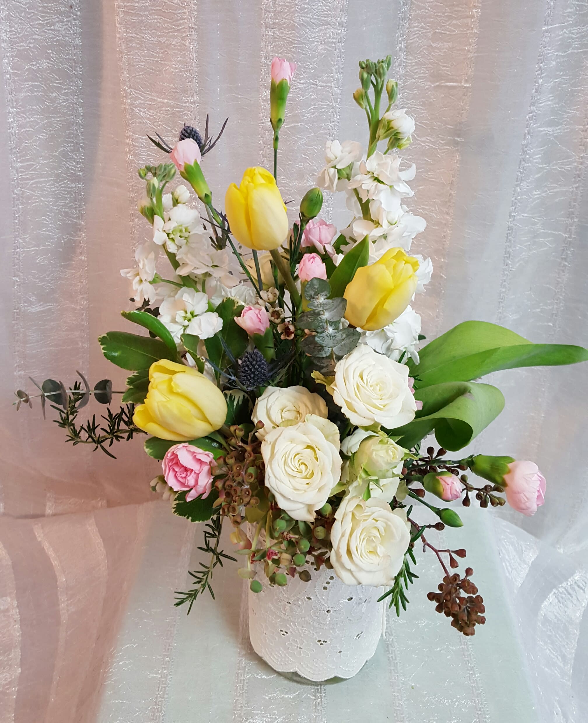 tulips and lace - Spray roses, tulips and sweetly scented stock provide a remarkable arrangement for your loved one.