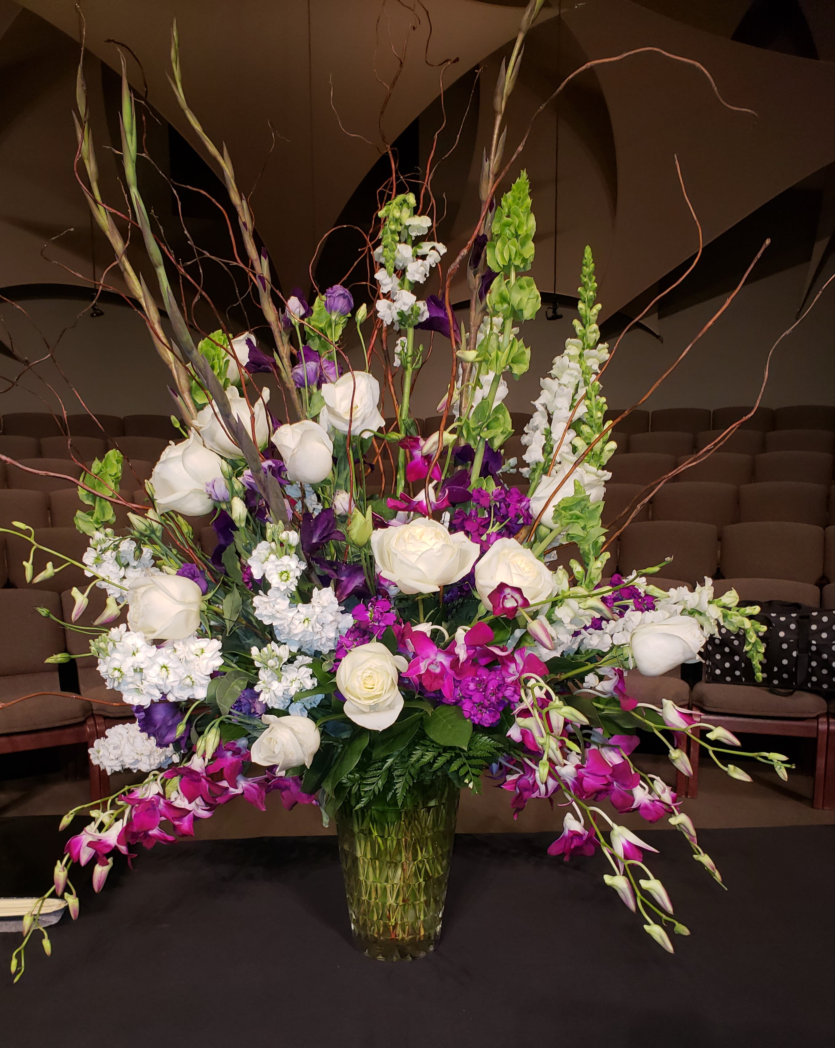 A Celebration Of Life A Celebration Of Life - This artfully designed arrangement full of dendrobium orchids, roses, liatris and other complimentary flowers will take your breath away.