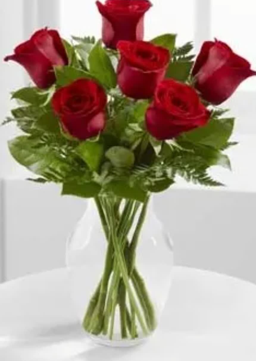 Simply Rosy - Six beautiful roses designed simply in a vase with greenery. Your choice of rose color.  Will use red or prettiest color on hand if not specified. 