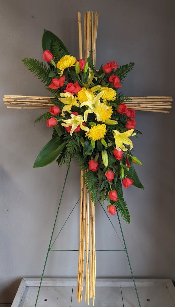 FUNERAL STANDING SPRAY - Bamboo Goodbyes - This is a wonderful option for a funeral service, church or graveside . This standing spray is a one sided flower arrangement on a 5' easel (easel included) displaying a spray approximately 3’5” tall and 2' wide. This colorful, tropical feeling spray with lilies, roses and bamboo is a beautiful option to memorialize an important person in your life.  **This is a piece for a funeral or memorial service. Please place the order at least 2 days prior to the service to guarantee a certain arrangement. Anything sooner and we cannot guarantee it will match the picture. These pieces can be customized to the color of your choice. The flowers may vary depending on availability of the flowers, special requests and quality of the flowers we have in stock. If you have a special request please add it to our special instructions when placing your order. If you have any questions please don’t hesitate to call. 714 289 1123**
