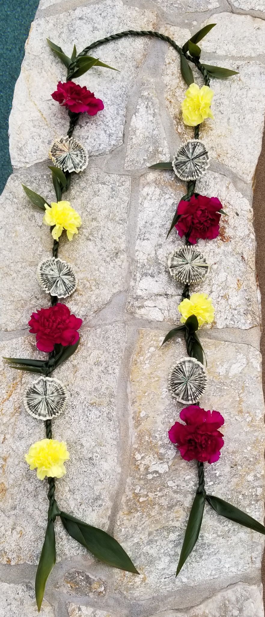 Pua Cash Ti-leaf Lei - SPECIAL LEI ORDER INSTRUCTIONS: FOR OPTION TO PICK UP YOUR ORDER, PLEASE CALL OR TEXT 858-598-3844  IF ORDERING FROM THE WEBSITE, PLEASE LET US KNOW YOUR COLOR PREFERENCE UNDER NOTES FOR THE FLORIST  *Pin wheel money not included. Each pin wheel consist of 2 bills. Example two $1, $5, $10, $20, $50, or $100 bills = One pin wheel.   When you give someone a Hawaiian lei, it is a heartfelt gift of love, friendship, appreciation, accomplishments, honor, and respect. Great for birthday celebrations, graduations, anniversaries, weddings, special events, funerals, paddle outs, promotions, etc. Made with Aloha. Leis can be custom made with many different color options. For custom made orders please text or call 858-598-3844  Leis Substitution Policy In some instances, our photo may represent an overall theme or look and include a one-of-a-kind which cannot be exactly replicated. Although the actual lei may not precisely match the photo, its temperament will. Occasionally, substitutions of flowers happen due to weather, seasonality and market conditions which may affect availability. If this is the case with the lei you've selected, we will ensure that the style, theme and color scheme of your arrangement is preserved and will only substitute items of equal value or higher value. If any design elements are of major importance to your order, please include them in the florist instructions at checkout or contact us to ensure availability