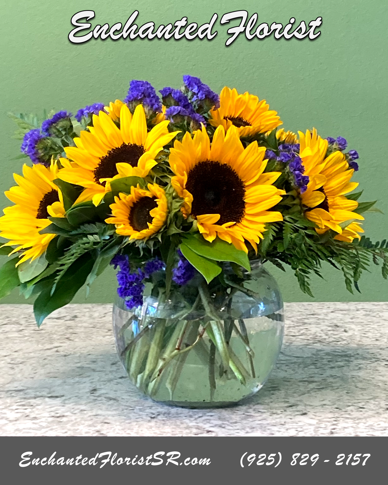 Bright Bowl - Mixed Arrangement - A radiant mixed arrangement that showcases vibrant and cheerful yellow Sunflowers that take center stage, gracefully accompanied by the striking hue of purple statice. Accented with freshly-cut lemon leaf and leather fern.  Arrives In: Clear glass bubble vase  Orientation: Any-Sided  Approximate Dimensions: 12&quot; Tall 14&quot; Wide 8&quot; Vase Diameter