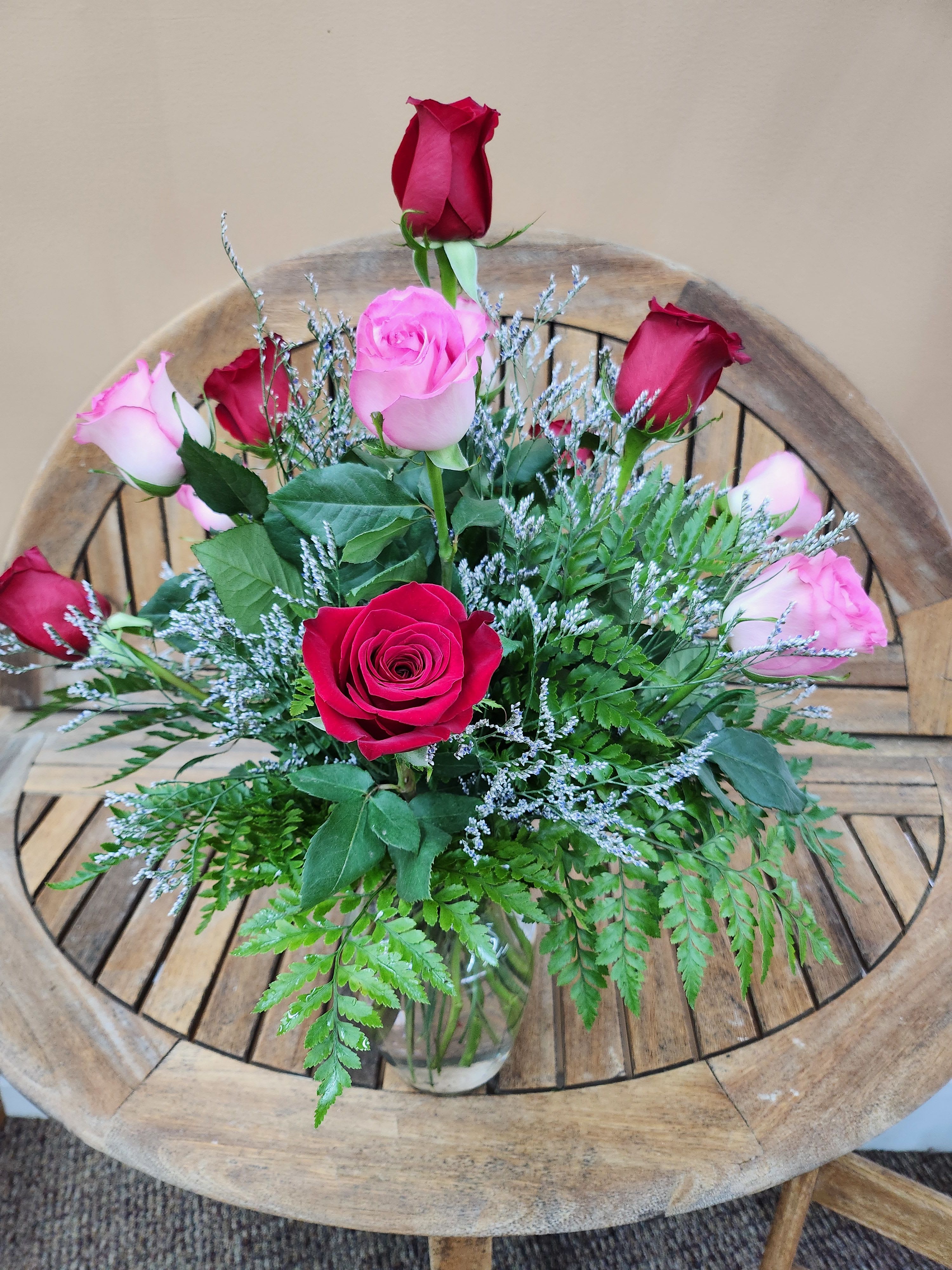 Dozen Red And Pink Roses  - Dozen mixed rones in pink and red. Arranged in vase with greens and filler. Pink Roses may vary in color.