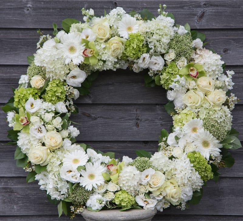 Sympathy Wreath - Gerberas, vendella roses, lisianthus, hydrangeas, spray roses, green hydrangeas, cymbidium orchids, and stock in a sympathy wreath. 