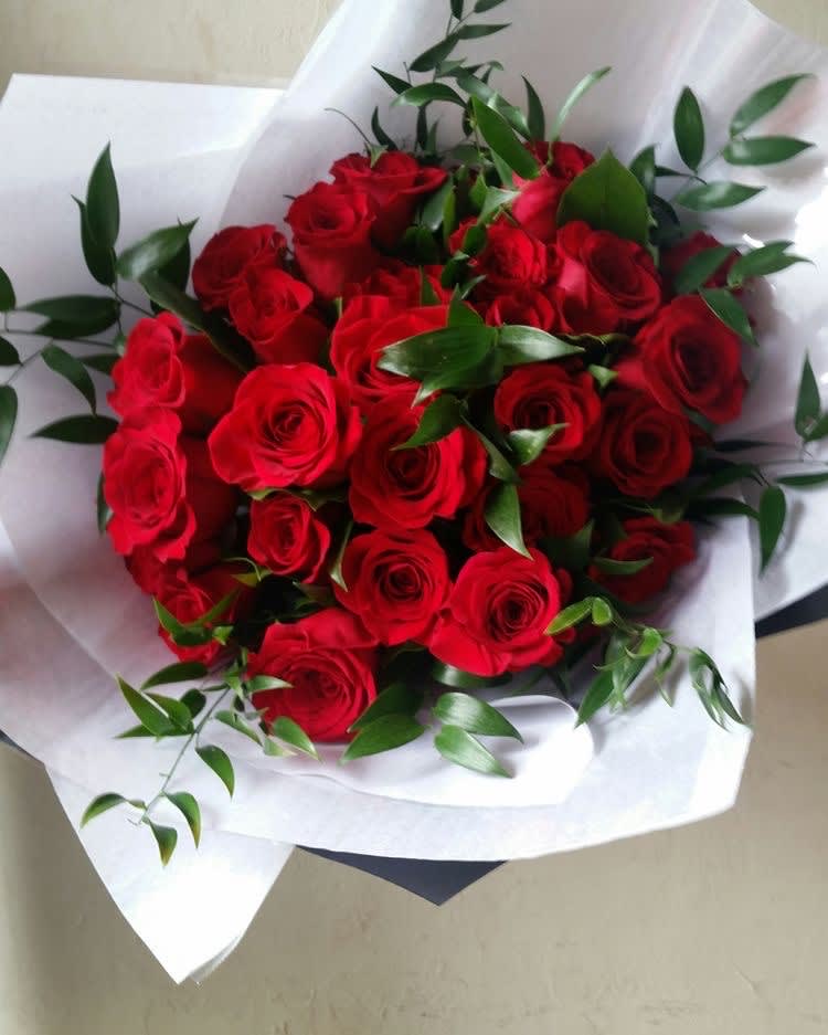 Dozen Rose Bouquet - A dozen roses with greenery in decorative wrapping.