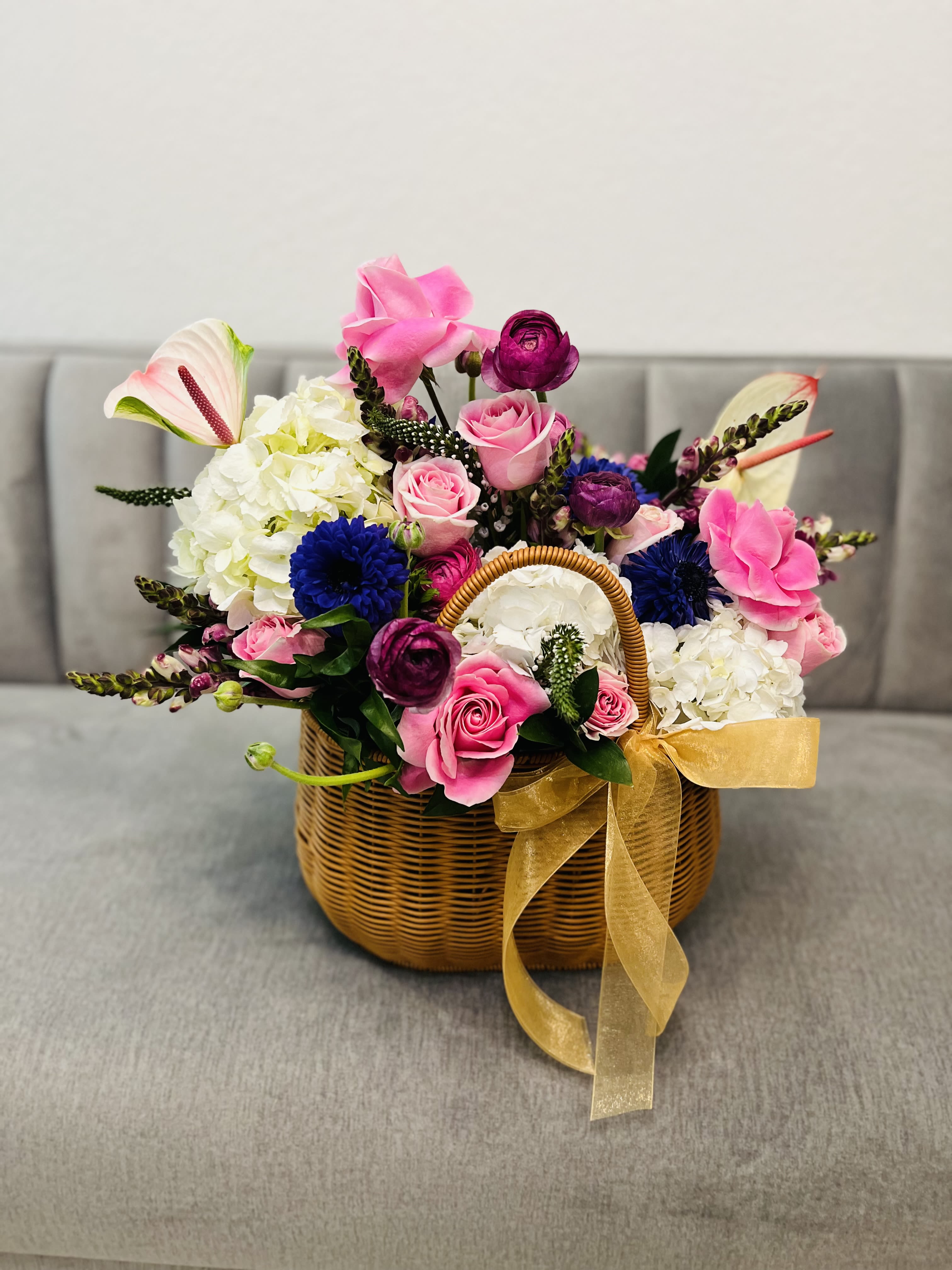 Basket of Joy Basket of Joy - A heartfelt mix of passionate pinks and soft pastels dances together in perfect harmony, symbolizing the beauty and depth of true affection. Nestled in a beautiful basket, this radiant arrangement is a poetic expression of your feelings.