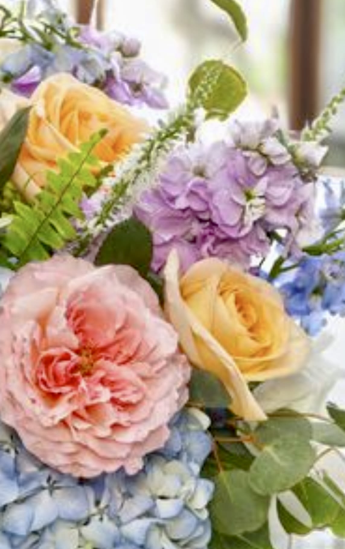 Whispers of Spring - A soft, garden-style arrangement overflowing with pastel pinks, sunny yellow, lavender, peach and sky blue blooms. Perfectly sweet for Mother's Day or anyone who loves the gentle beauty of spring. Bloom types will vary, 