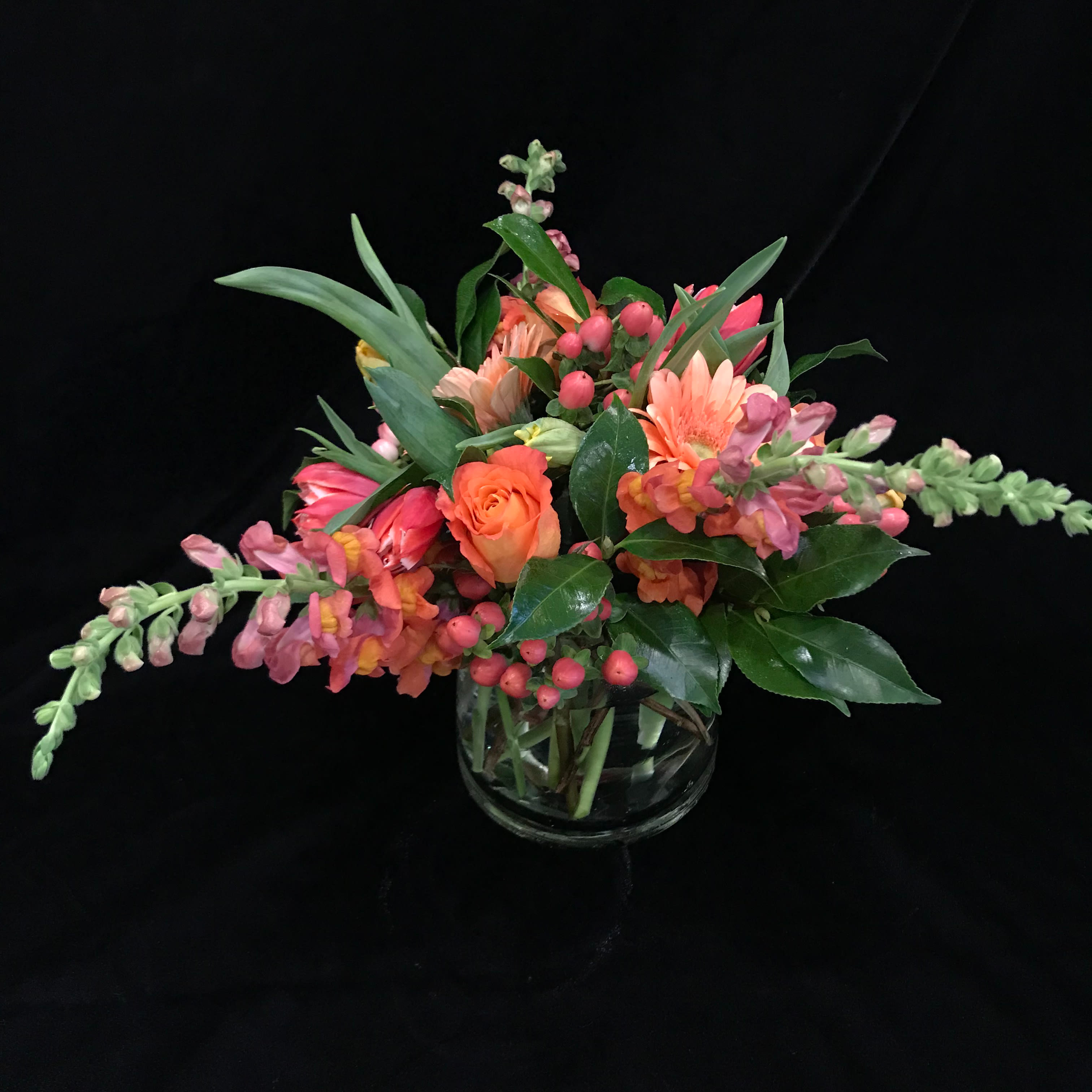 Coral Crush - A vibrant beautiful mix of coral and pink snapdragons, roses, tulips, gerbera daisies and hypericum berries would make anyone smile.