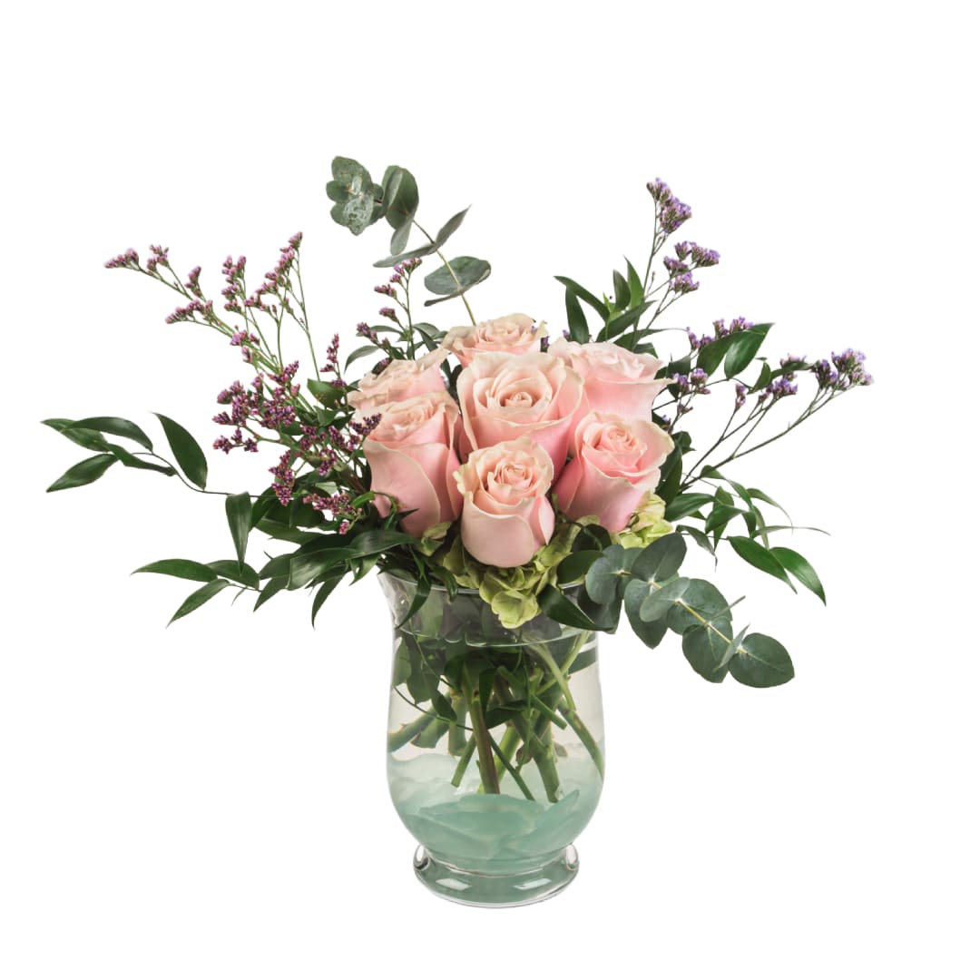 Daydreaming by BloomNation™ Daydreaming by BloomNation™ - Blush roses (7) with limonium and a variety of greenery come together for a lovely arrangement. A stylish and sweet way to dress up any space, send this arrangement for any special occasion or Just Because. Feel free to request a different rose color. Deluxe adds 3 roses. Vase may vary.