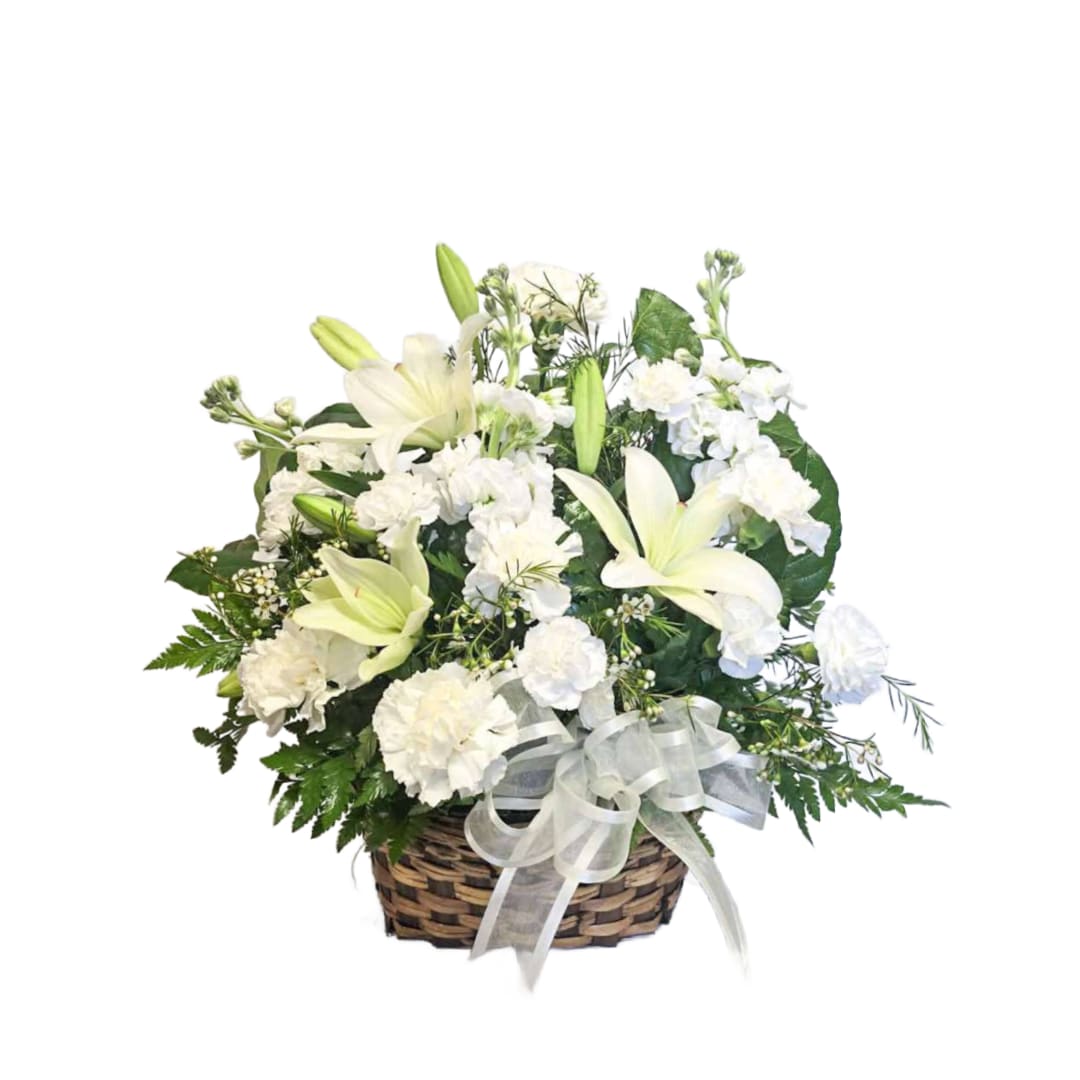 Lily Tribute Lily Tribute - This all white arrangement comes in a weaved basket with fragrant lilies, snaps, carnations, mini carnations and mixed greens