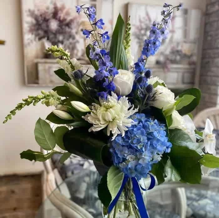 Blue Skies Blue Skies - A beautiful vase arrangement with blue and white flowers is sure to Wow!