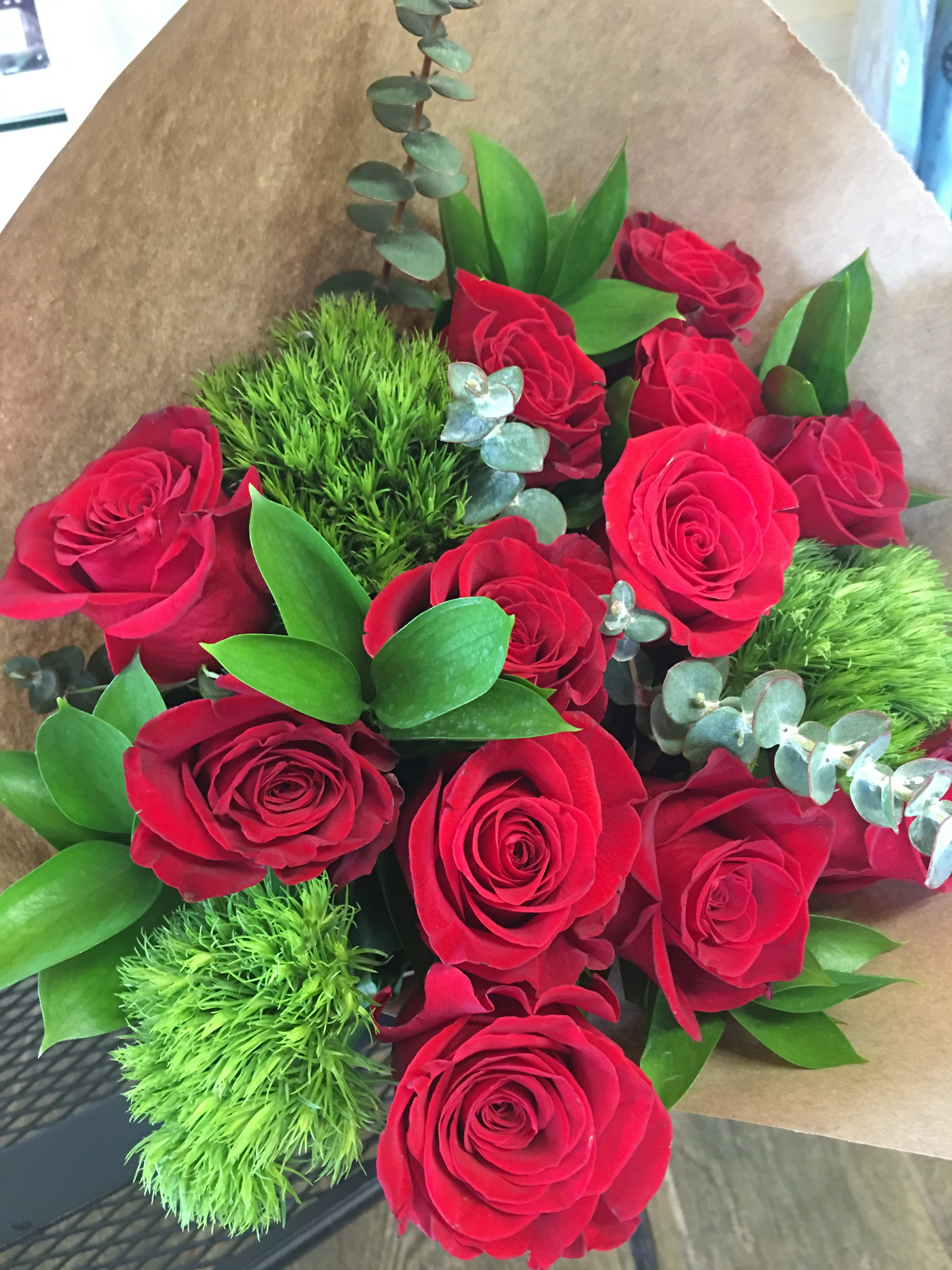 Nature Green &amp; Roses   - hand-bouquet consist on 12 red roses, dianthus, and foliage wrap in brown paper 