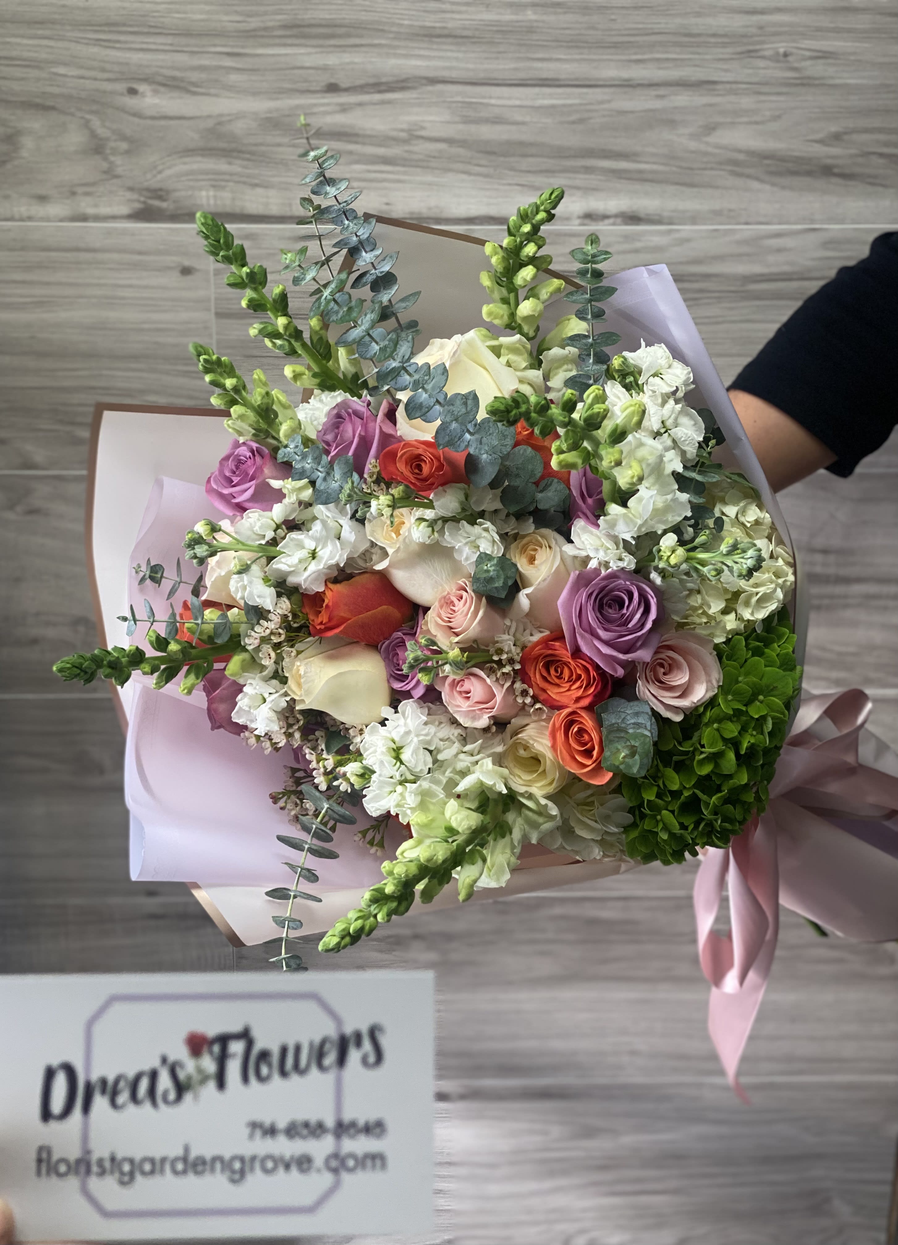 Bundle Of Joy Bundle Of Joy - 2 dozen mixed color long stem roses , with snapdragon, wax, hydrangea , and eucalyptus.