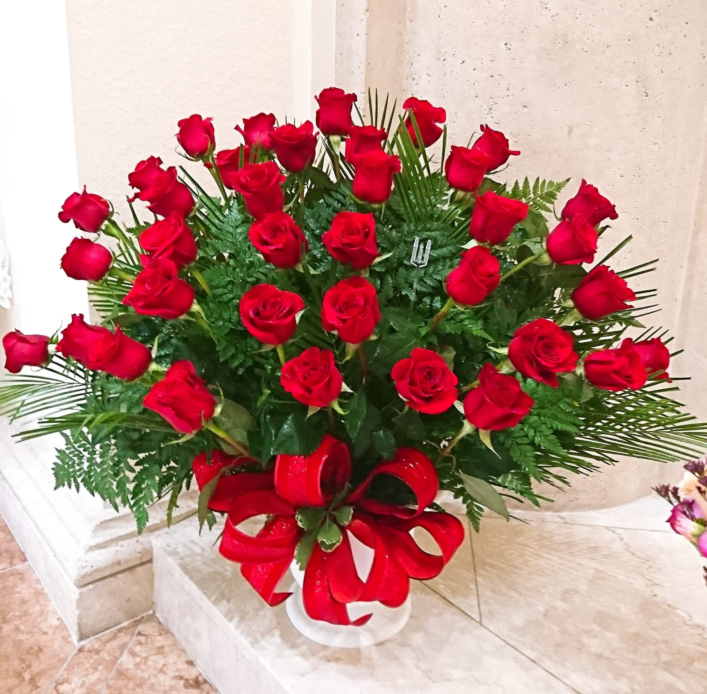 The Soul of Splendor Arrangement The Soul of Splendor Arrangement - The Soul's Splendor Arrangement is a rich display of the love shared throughout the life of the deceased. Brilliant red roses are elegantly displayed in a white designer plastic urn and accented with lush greens and red satin ribbon to create a beautiful tribute to honor your special relationship. STANDARD arrangement includes 36 roses. DELUXE arrangement includes 48 roses. PREMIUM arrangement includes 60 roses.