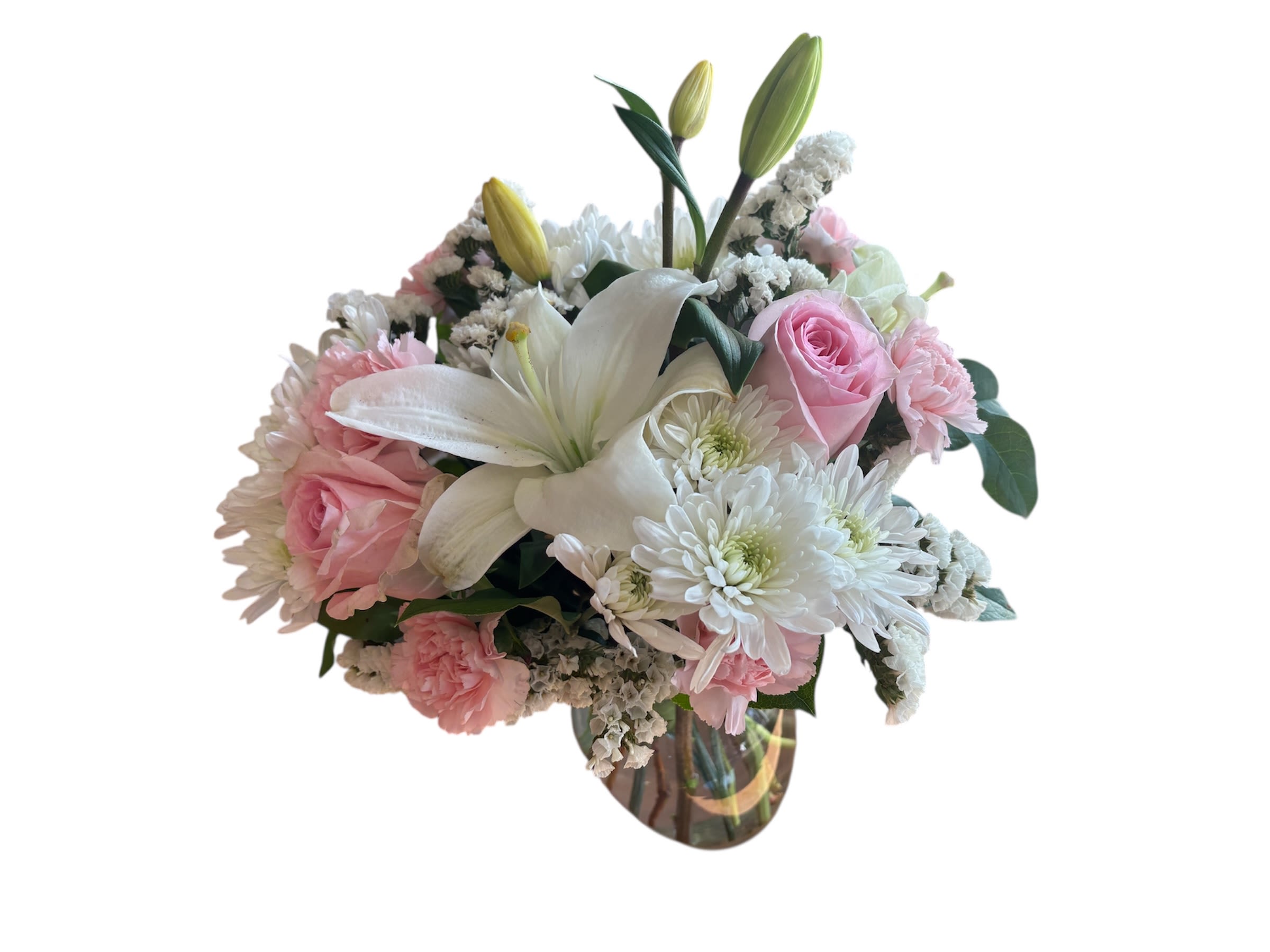 Pink Dream  Bouquet - Classically elegant in a way that will never go out of style, this fresh flower arrangement is truly a dream. Pink roses and pink mini carnations are soft and sophisticated amongst a bed of white Lilies, chrysanthemums, and statice, perfectly accented with lush greens while situated in a classic clear glass vase. A gorgeous birthday, thank you, or Mother's Day gift!