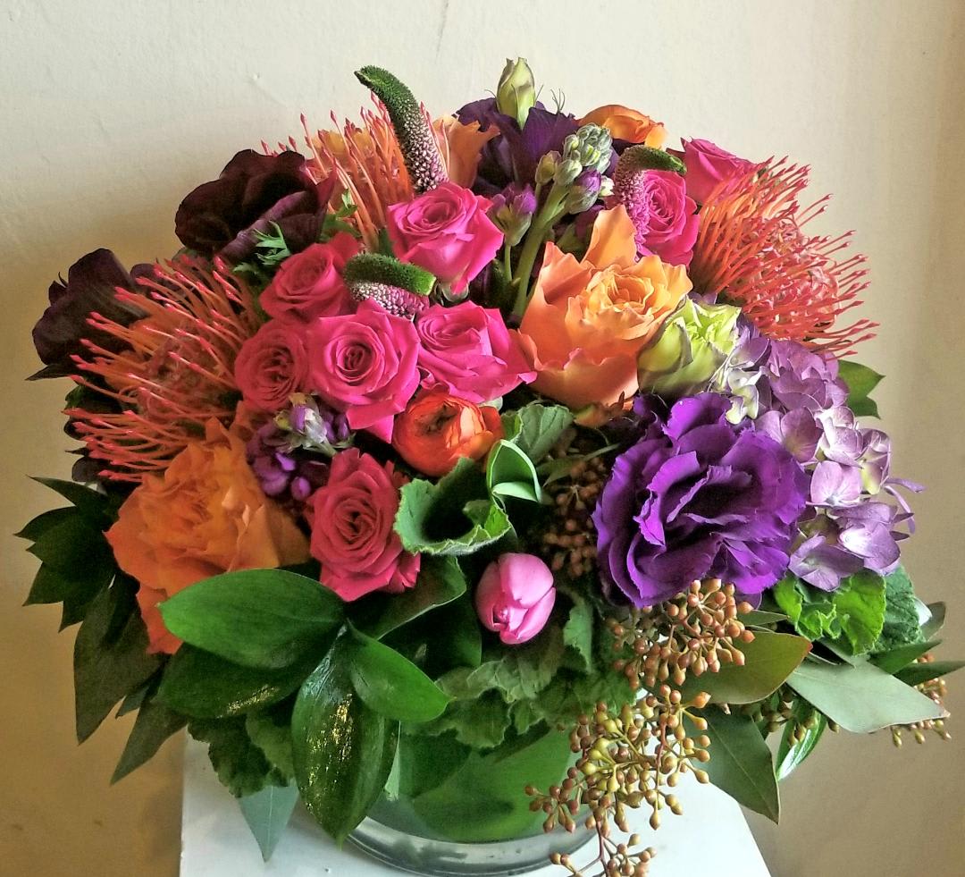 Del Mar Sunset Del Mar Sunset - Purple, orange and pink flowers arranged. **tropical flowers upon availability** may be substituted for an equivalent.
