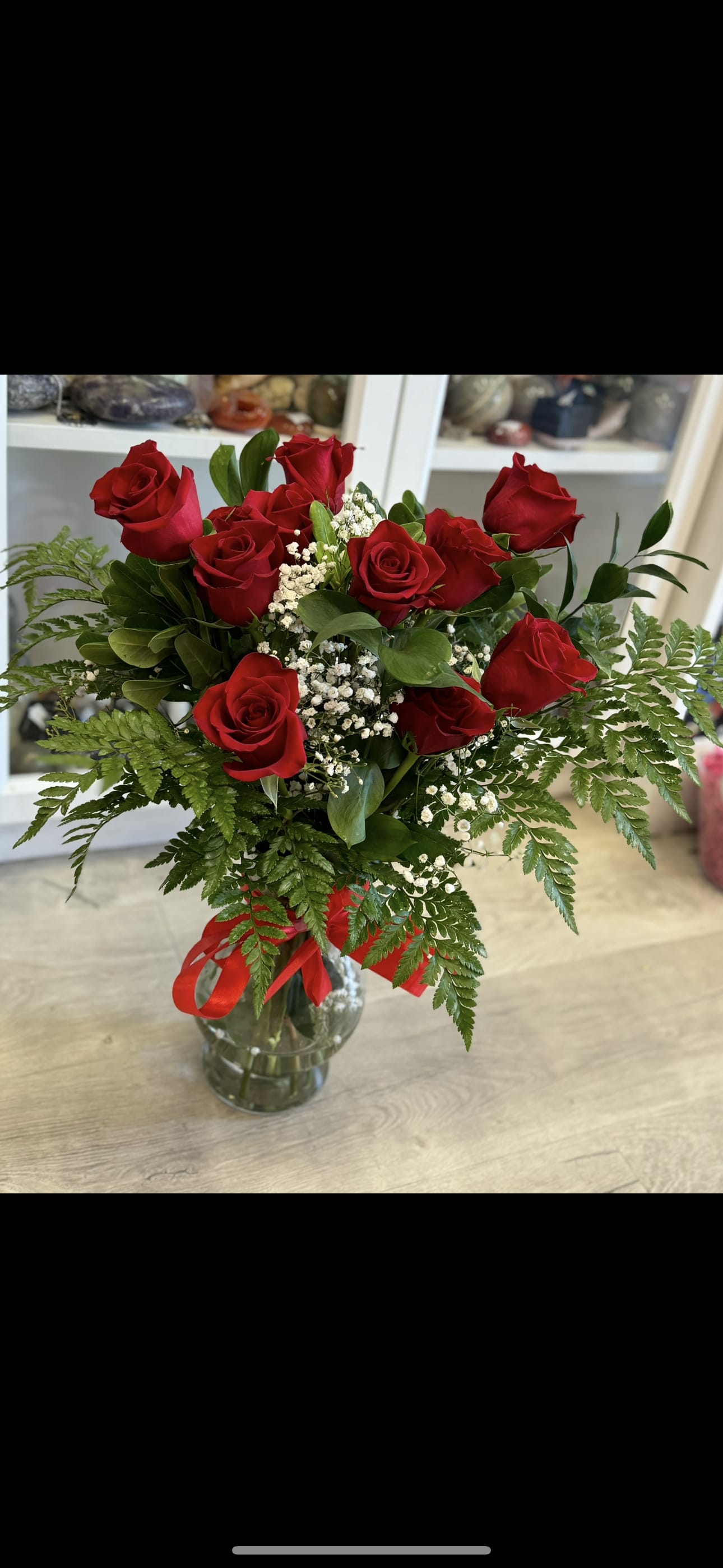1 Dozen Roses -Best Seller - Experience the romance and beauty of our stunning one dozen red roses, elegantly arranged in a charming vase. Each rose is vibrant and fresh, symbolizing love and passion, perfect for expressing heartfelt emotions. Accompanied by delicate baby's breath and assorted greenery, this arrangement adds a touch of softness and elegance.  Tied together with a beautiful ribbon, this bouquet is arranged in a vase . Complete with a personalized sticker, it’s ready to make any occasion memorable. Ideal for anniversaries, birthdays, or just because, our one dozen red roses will surely impress and delight!  ---  Let me know if you'd like any changes or additional details! 