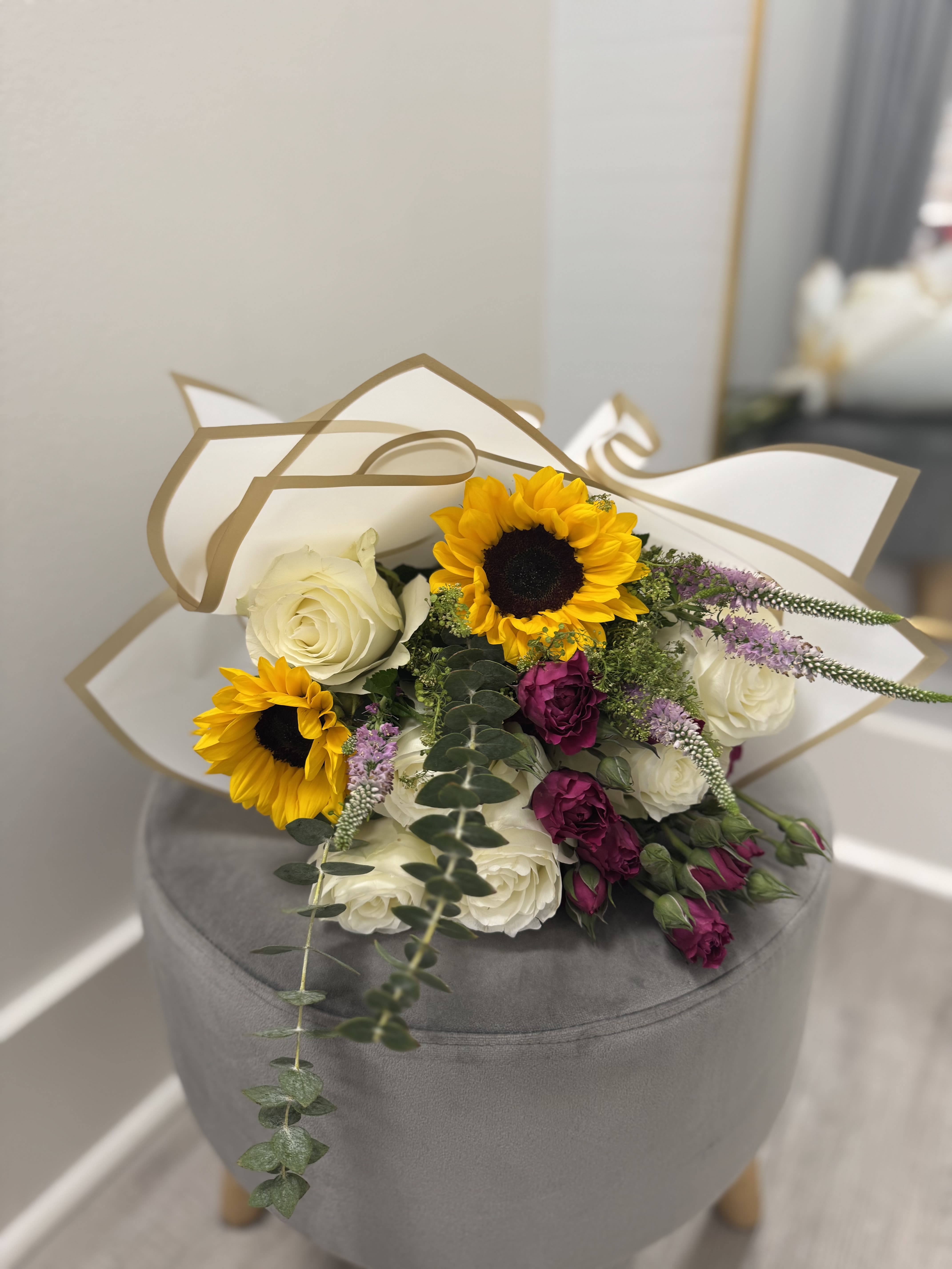 Big Bouquet-Best Seller  - Elevate any occasion with our Big Bouquet!  Featuring 6 vibrant roses, 2 cheerful sunflowers, and fragrant eucalyptus, all elegantly wrapped in deluxe floral paper and tied with a ribbon. The perfect blend of beauty and joy! Rose Colors Vary Based On Availability. 