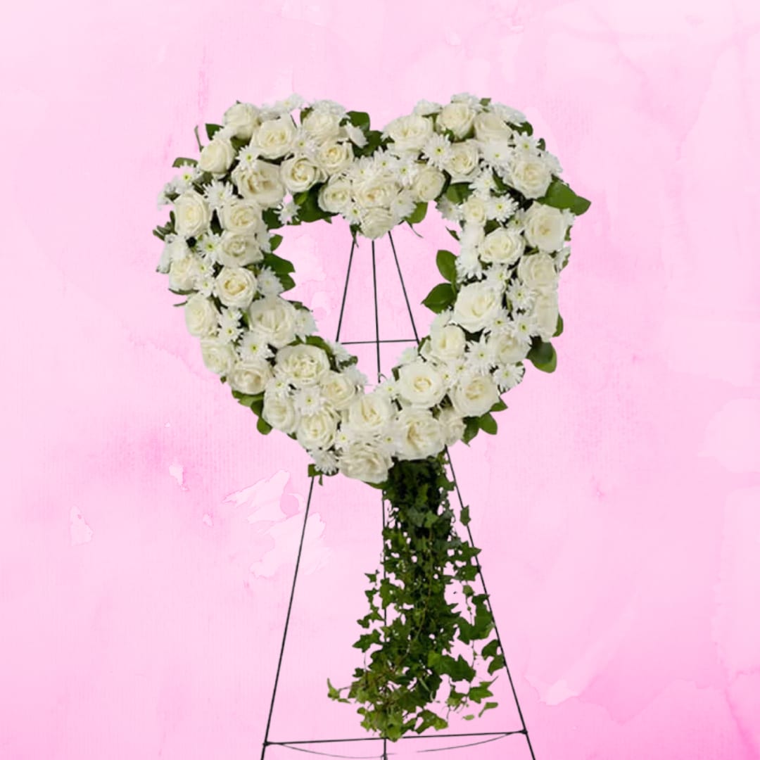 Love in our Hearts by BloomNation™ Love in our Hearts by BloomNation™ - An all white tribute, this heart shaped easel shows your everlasting love. Featuring a variety of white flowers and greenery, this heart with a trail of ivy compliments the beauty of life.
