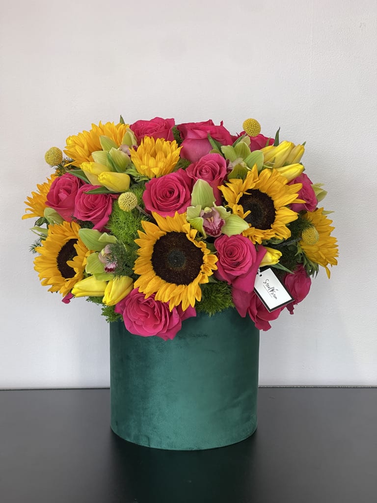 Emerald Fantacy Emerald Fantacy - A luxury arrangement of hot pink roses, sunflowers, tulips and orchids flourish a bright and cheerful garden.