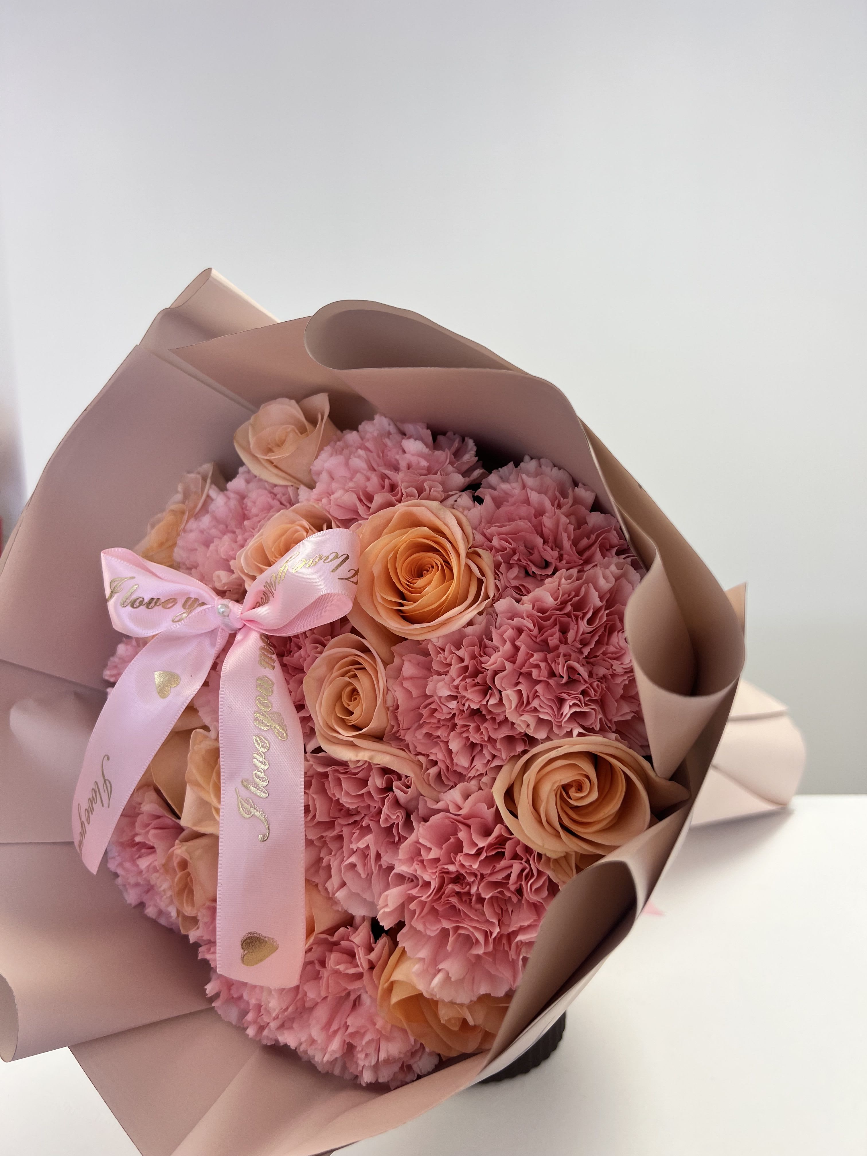 Tiffany Bouquet - This beautiful bouquet is perfect for Mother’s Day or birthday. Made with 12 premium Ecuadorian roses and a dozen of pink carnations. Carefully wrapped with waterproof paper and ribbon to accent. 