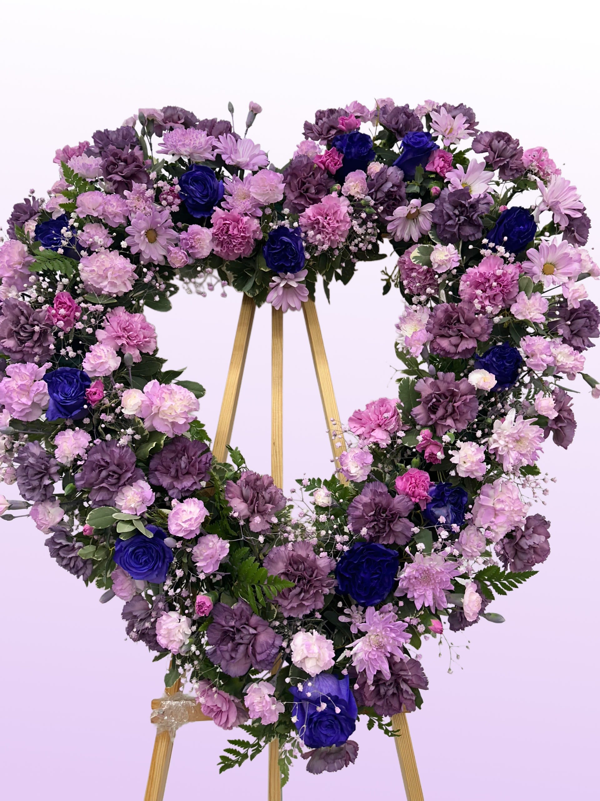 Violet Dreams - This wreath, with its stunning shades of purples feels regal and soothing.  If some flowers and/or the vase are not available there will be minor substitutions