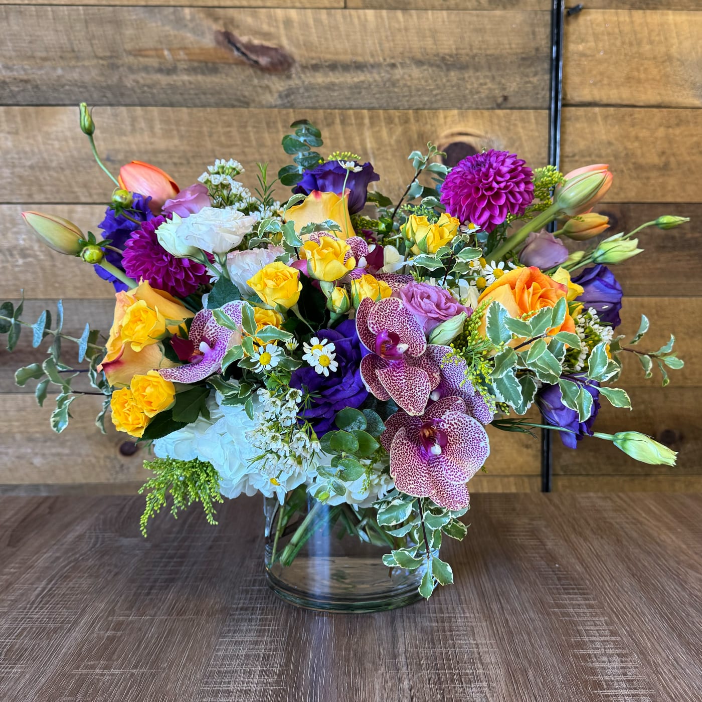 Gran Canaria Gran Canaria - A mixture of yellow and purples flowers, which include roses, tulips, spray roses, hydrangeas, orchids, lisianthus, greenery and fillers.