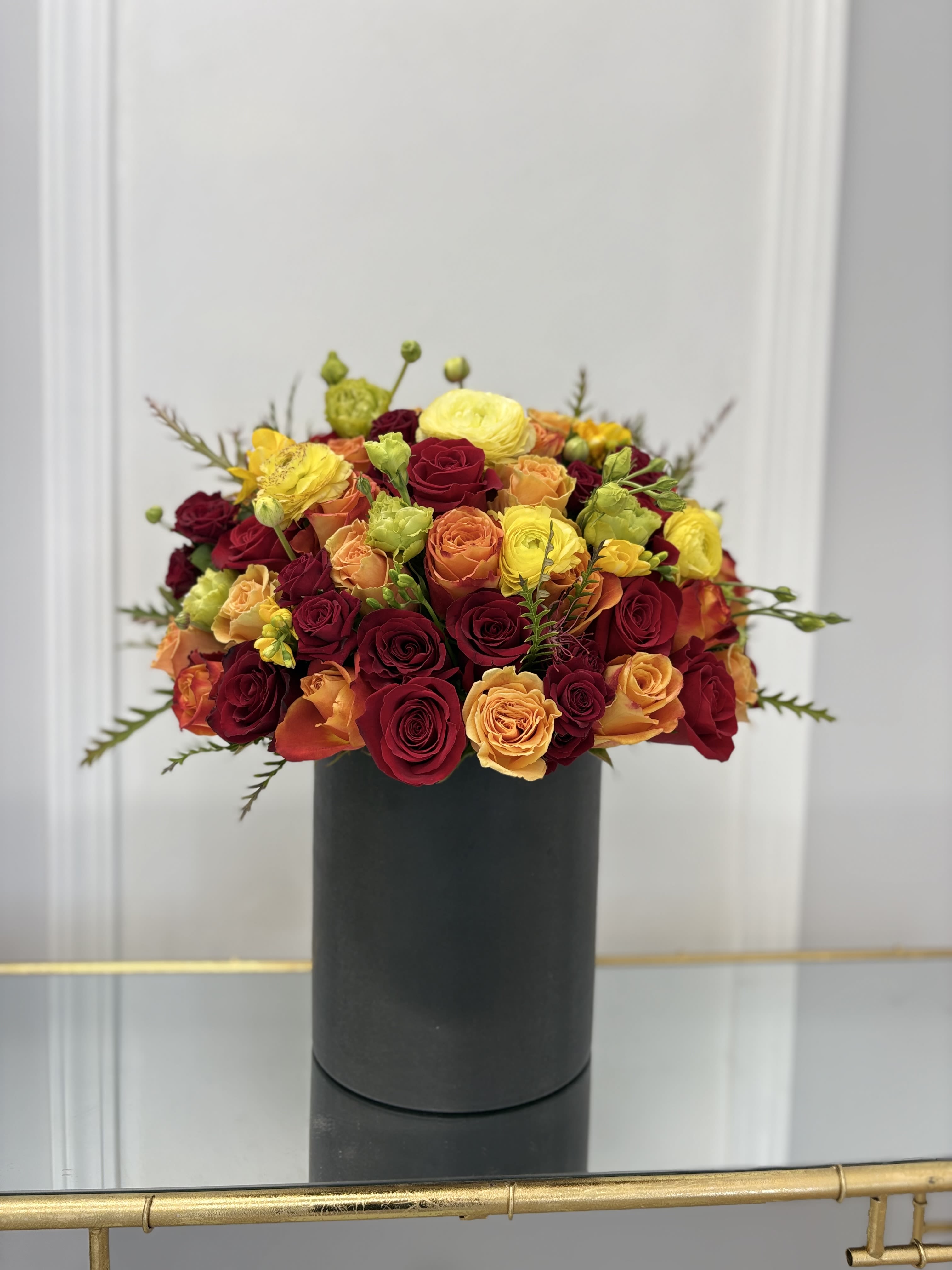 Summer Beauty Hat Box By VLM Flowers - We have mixed roses, ranunculuses, freesia, and lisianthus in bright shades to bring you a bright mood. The photo is deluxe size.