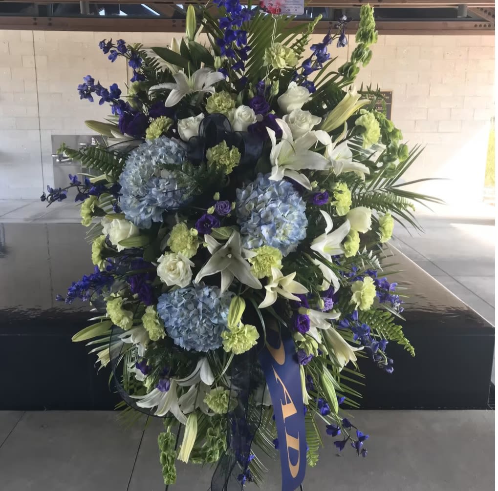 White and blue flowers for funeral  - Blue and white elegant funeral arrangements on a standing spray honoring the memories of a loved one at the wake, funeral or memorial services